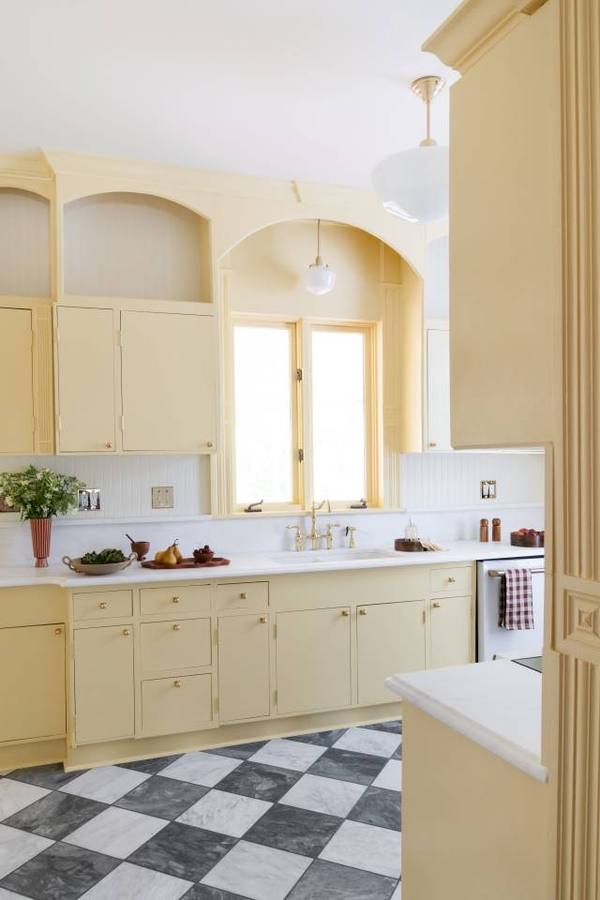 Butter yellow kitchen with arched cabinetry
