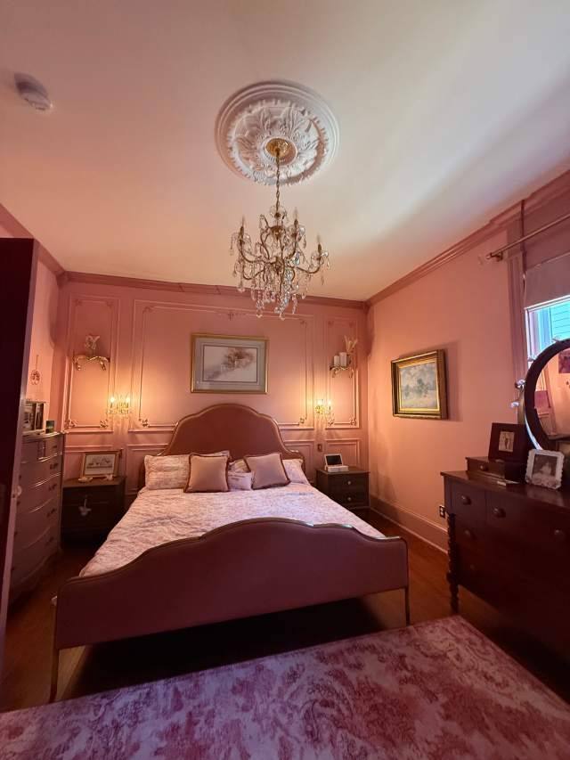 The Pink Room bedroom with ceiling medallion and chandelier