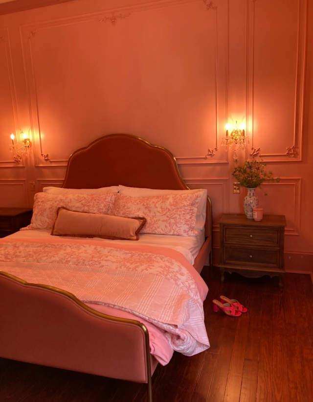 The Pink Room, a blush bedroom with crystal sconces and panel moulding