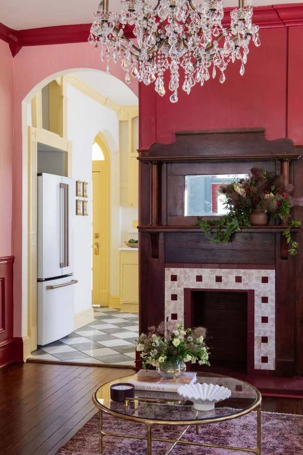 Crimson fireplace with antique mantel and flowers